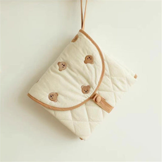 Baby swaddle with bear patterns on a light background